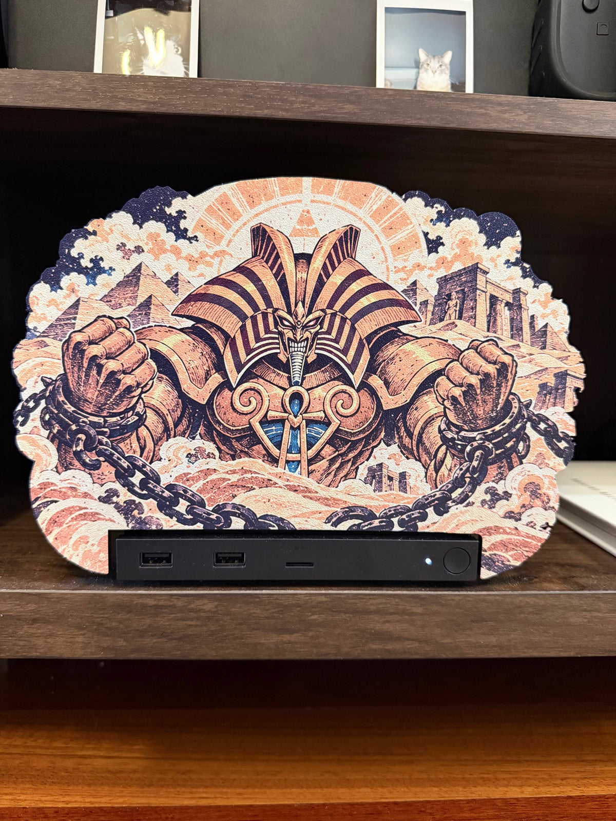 The Forbidden One oversized Steam Machine faceplate straight on front view mounted on the Steam Machine on a shelf