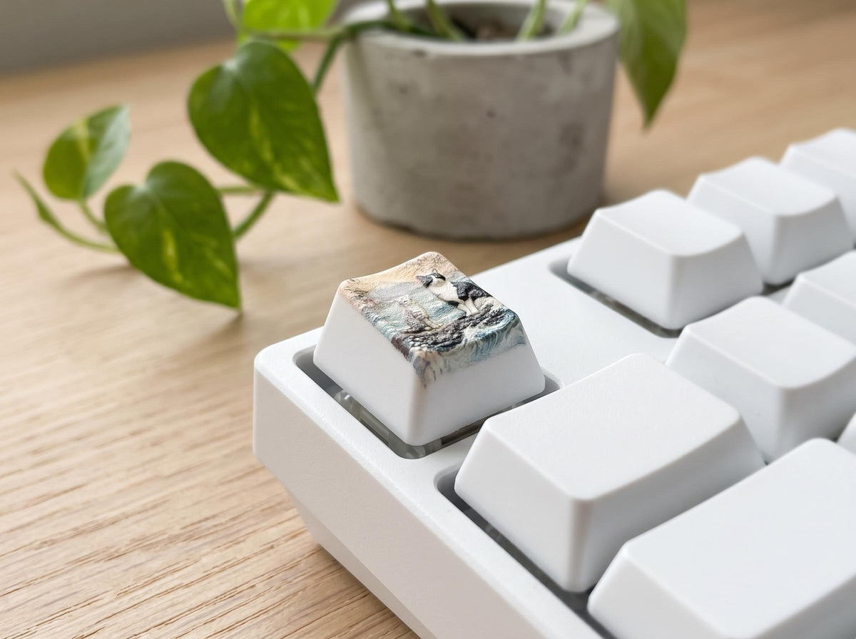 Custom Pet Photo ESC Keycap, Cherry MX Compatible, Dog Cat Memorial Keyboard Accessory with the painted two-cats beach illustration, shown on a white mechanical keyboard on a light wood desk with a potted plant behind