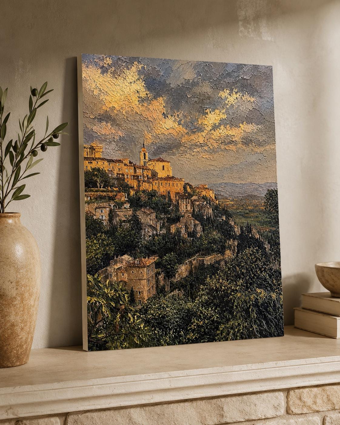 Tuscany Hill Town Textured Painting Print canvas leaning against a wall on a stone mantelpiece, styled beside a ceramic vase with greenery and stacked books