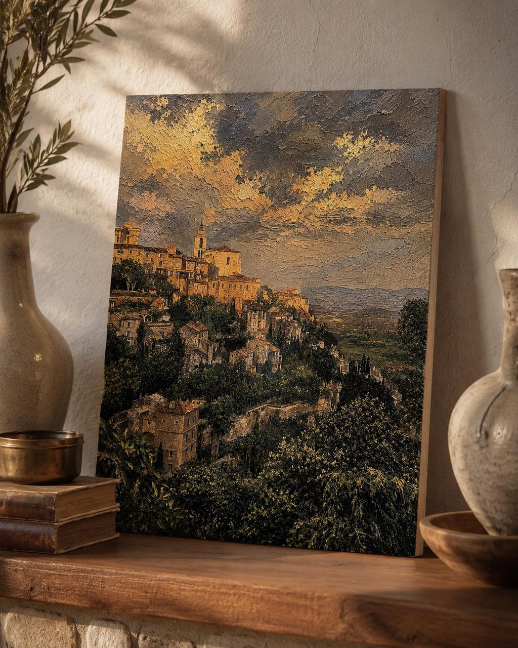 Tuscany Hill Town Textured Painting Print canvas of the Italian hillside village under a dramatic golden sky, styled on a rustic wooden mantel with ceramic vases and books