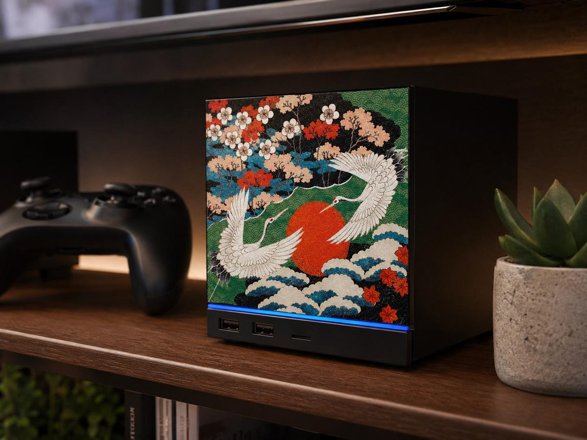 Japanese Crane Steam Machine Faceplate – UV Printed Front Panel | Red Sun & Cherry Blossom Art | Custom Mini PC Cover | Gamer Gift, crane faceplate installed on the console on a wooden shelf, with a black game controller to the left and a potted succulent to the right, and a television behind
