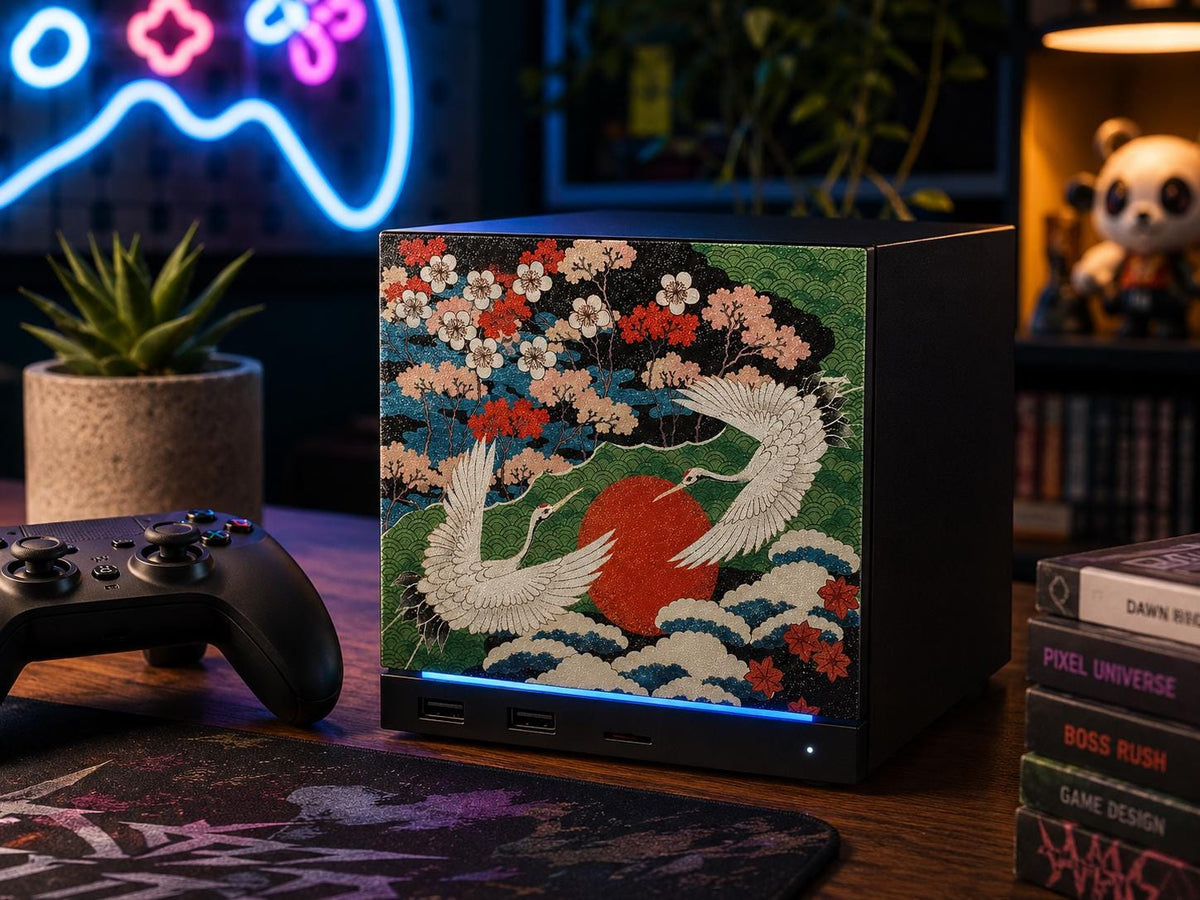 Japanese Crane Steam Machine Faceplate – UV Printed Front Panel | Red Sun & Cherry Blossom Art | Custom Mini PC Cover | Gamer Gift, crane faceplate installed on the console on a wooden desk in a styled gamer room, with a Steam controller, a succulent, a stack of gaming books, and a neon controller sign nearby