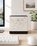 Botanical Line Art Steam Machine Faceplate | Minimalist Plant UV Print Skin with a delicate black line-drawn flower and leaves, shown installed on the console on a light wood desk beside a white keyboard and mouse