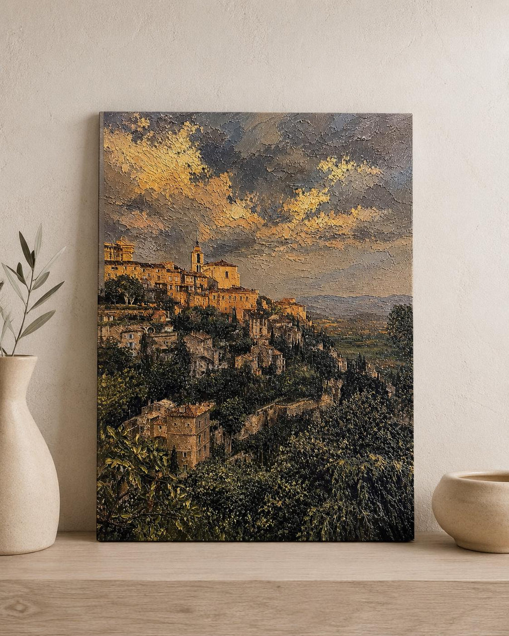 Tuscany Hill Town Textured Painting Print styled on a light wood surface beside a white ceramic vase and a small bowl against a textured beige wall