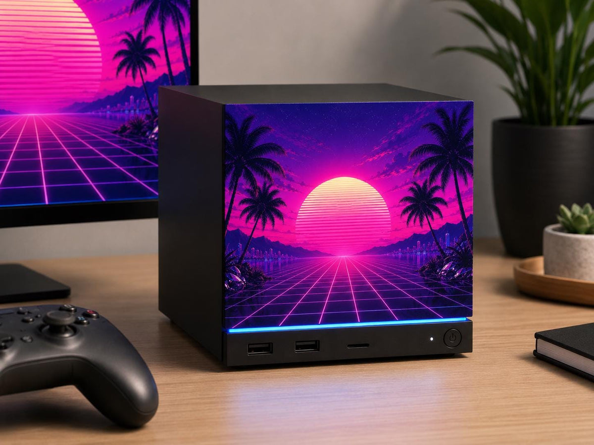 Synthwave Steam Machine Faceplate UV Printed Front Panel | Retro Neon Sunset Grid Art | Custom Mini PC Cover | Gamer Gift, Steam Machine with the synthwave neon sunset faceplate installed on a wooden desk, beside a monitor showing the same artwork and a game controller