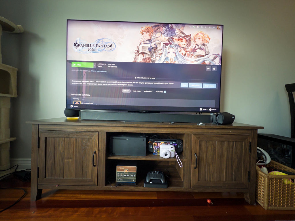 Retro Woodgrain Steam Machine Faceplate – 70s Atari Inspired Console Cover, wide view of a wooden media console with a TV showing Steam, the Steam Machine with the retro woodgrain faceplate installed on the open shelf below next to a game controller