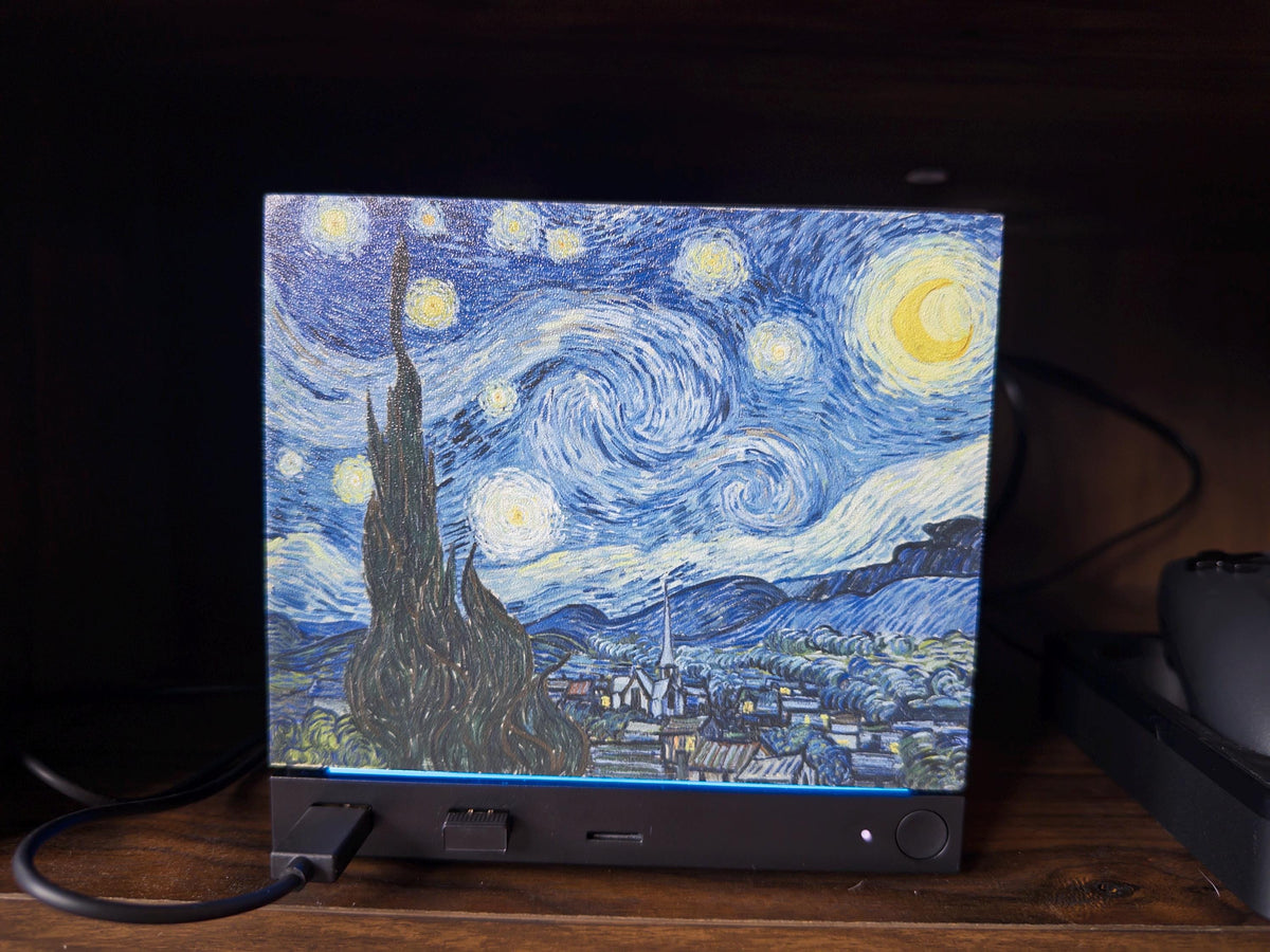 Starry Night Steam Machine Faceplate: Van Gogh Art UV Printed Magnetic Panel, close-up of the Starry Night faceplate installed on the Steam Machine with its power cable plugged in, glowing on a dark wooden shelf