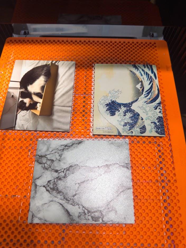 Custom Steam Machine Faceplate, Build your own Personalized Magnetic Cover Plate, Your Photo or Art UV Printed, Gamer Gift Valve Steam, three sample printed faceplate panels, a black and white cat photo, The Great Wave and a white marble design, lying on an orange perforated build plate