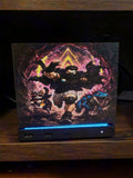 Dungeon Crawler Carl Steam Machine Faceplate | Licensed Landfin Studio Art (UV Printed) with Carl mid leap through a glowing dungeon portal, close-up front view installed on the console on a dark wooden shelf