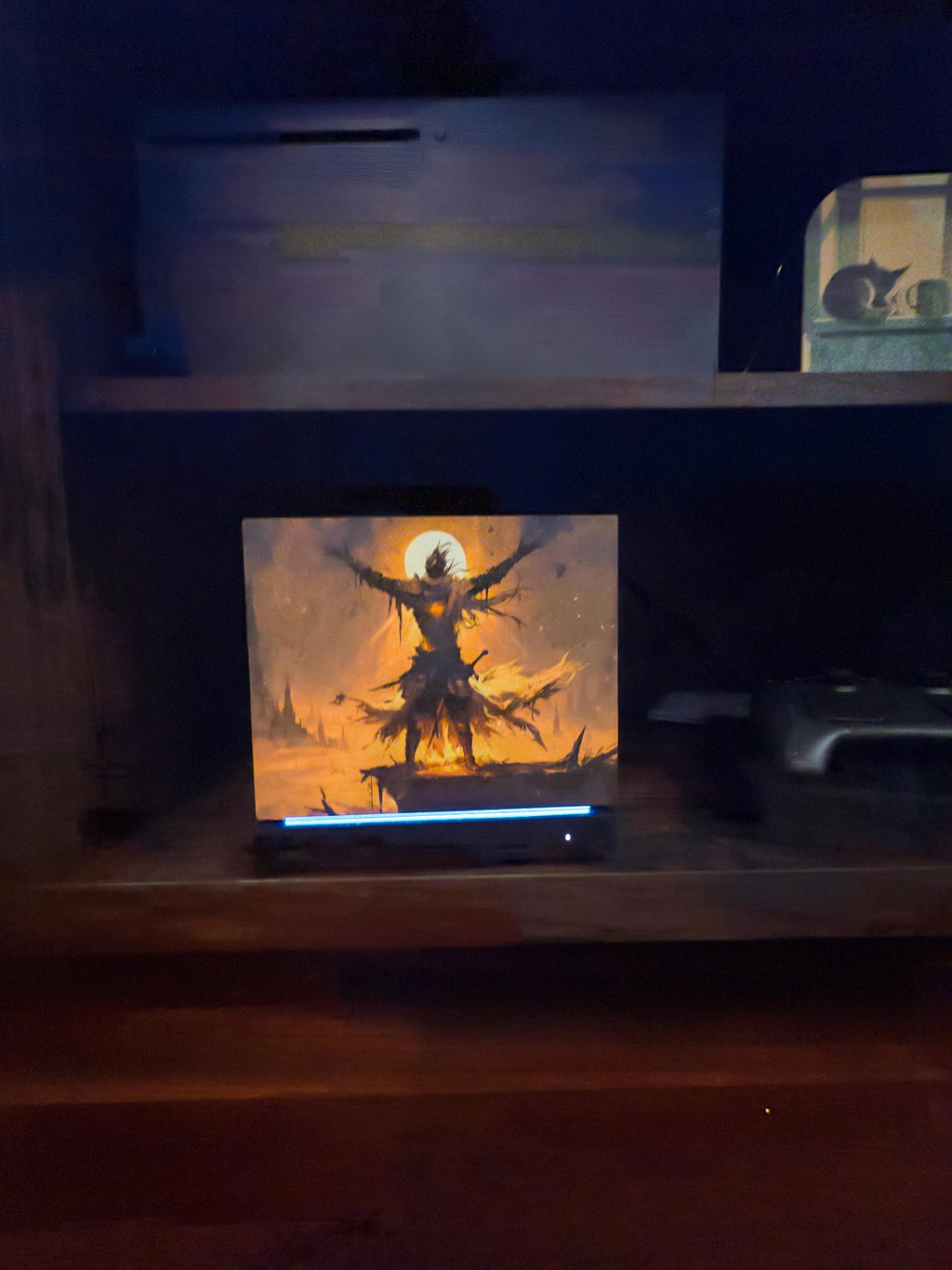 Praise the Sun Steam Machine Faceplate – Dark Fantasy Silhouette (Magnetic UV Print) with a warrior with outstretched arms against a glowing sun, shown installed on the console in a dark room with wooden shelves and other items in the background