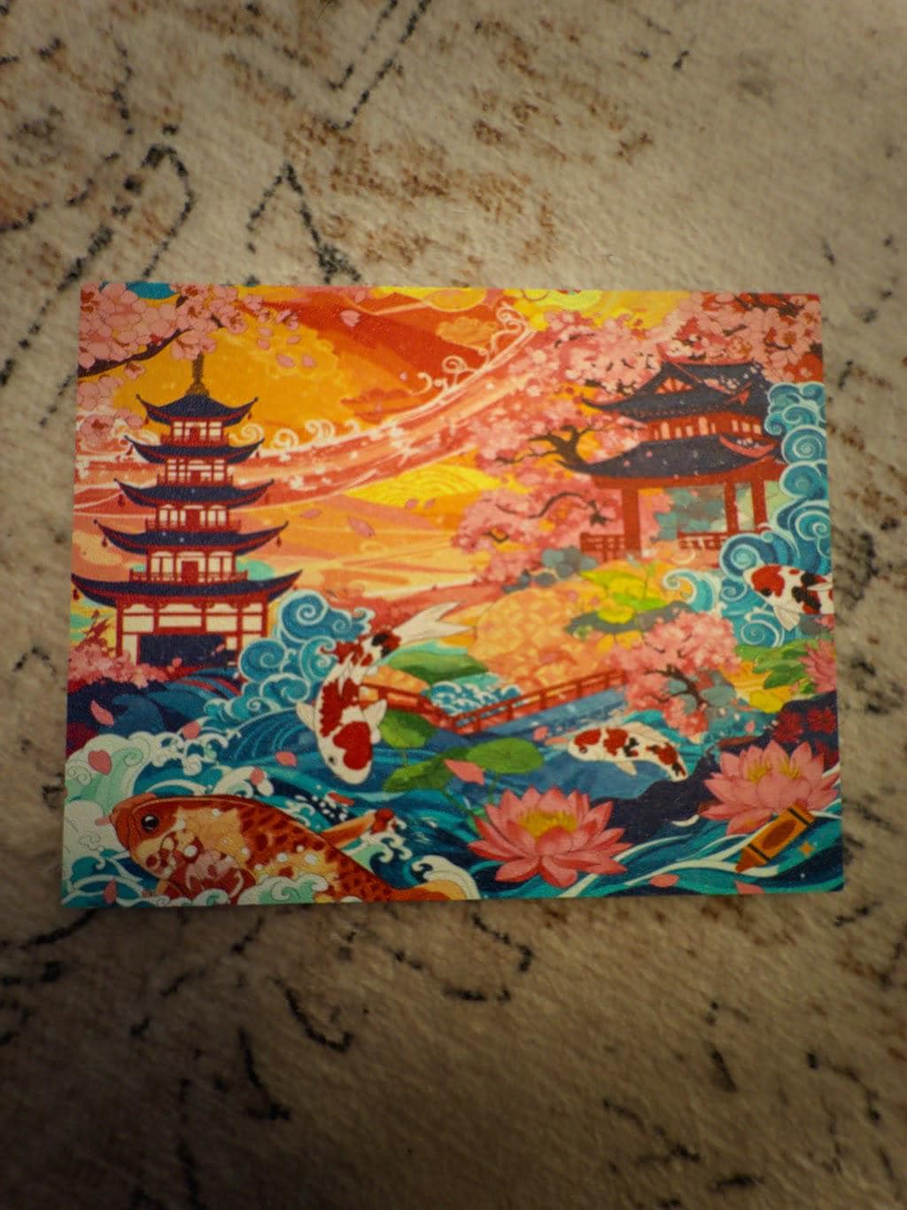 Koi Pagoda Garden Art | Steam Machine Faceplate | Cherry Blossom Sunset Panel | Magnetic UV Printed Cover | Japanese Gamer Gift with the pagoda, cherry blossom, koi fish and lotus flower artwork, top-down view of the detached panel laid flat on a beige textured surface