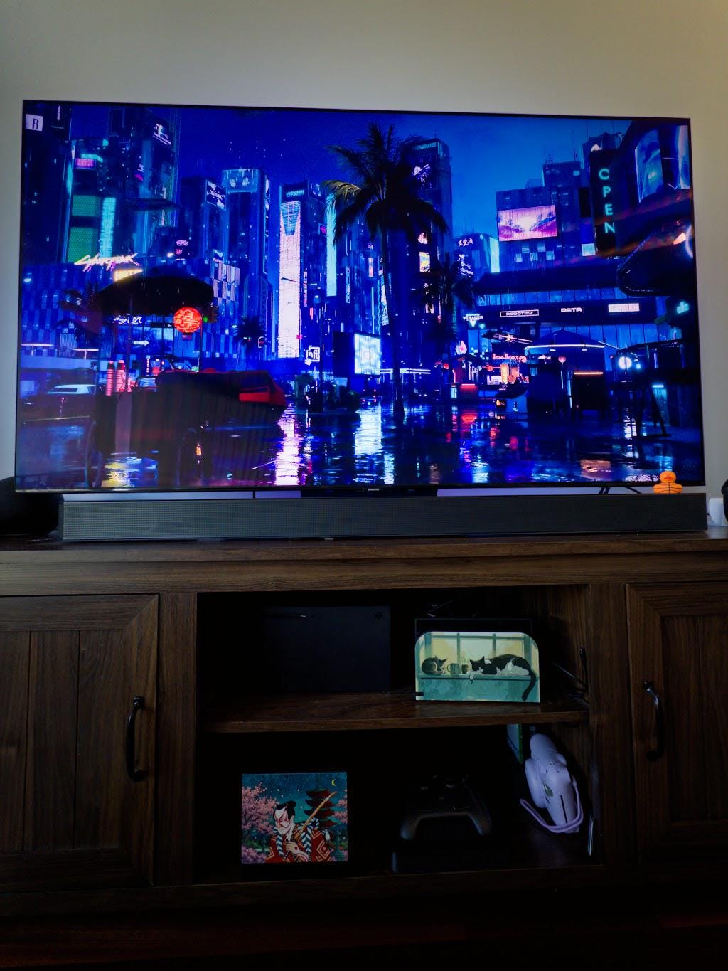 Kabuki Samurai Art Steam Machine Faceplate | Ukiyo-e Style Sword Panel | Magnetic UV Printed Cover | Japanese Gamer Gift with the kabuki actor artwork, visible on the console in the lower-left cubby of a wooden media console beneath a large TV showing a neon cityscape