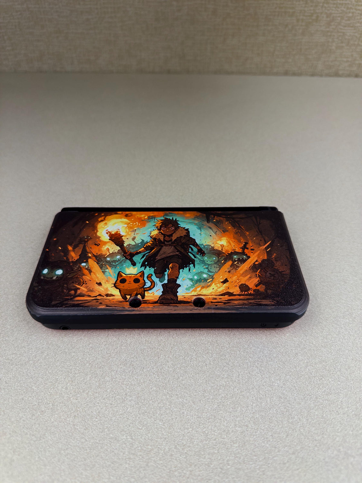3DS XL Custom Lid, Full Color UV Printed Snap On Cover, Top Shell Faceplate for Original 3DS XL, Your Own Image, Interchangeable Lid, top-down photo of the closed 3DS XL with the Torchlight fantasy artwork lid installed on a light gray surface