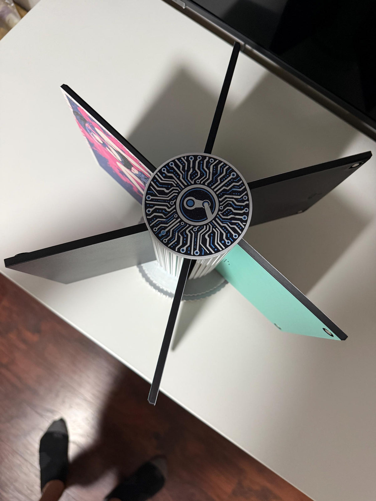 Steam Machine Faceplate Organizer, Spinning 3D Printed Display Stand, Rotating Plate Holder, Gamer Desk Setup, Gift for Gamer, Holds 6, top-down angled view of the organizer with six arms holding faceplates on a white desk