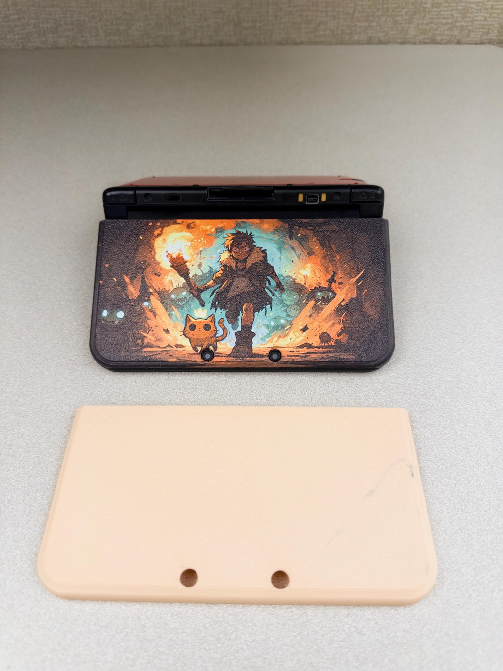 3DS XL Custom Lid, Full Color UV Printed Snap On Cover, Top Shell Faceplate for Original 3DS XL, Your Own Image, Interchangeable Lid, 3DS XL with the Torchlight fantasy artwork lid installed, shown next to an unprinted beige blank lid shell on a light gray surface