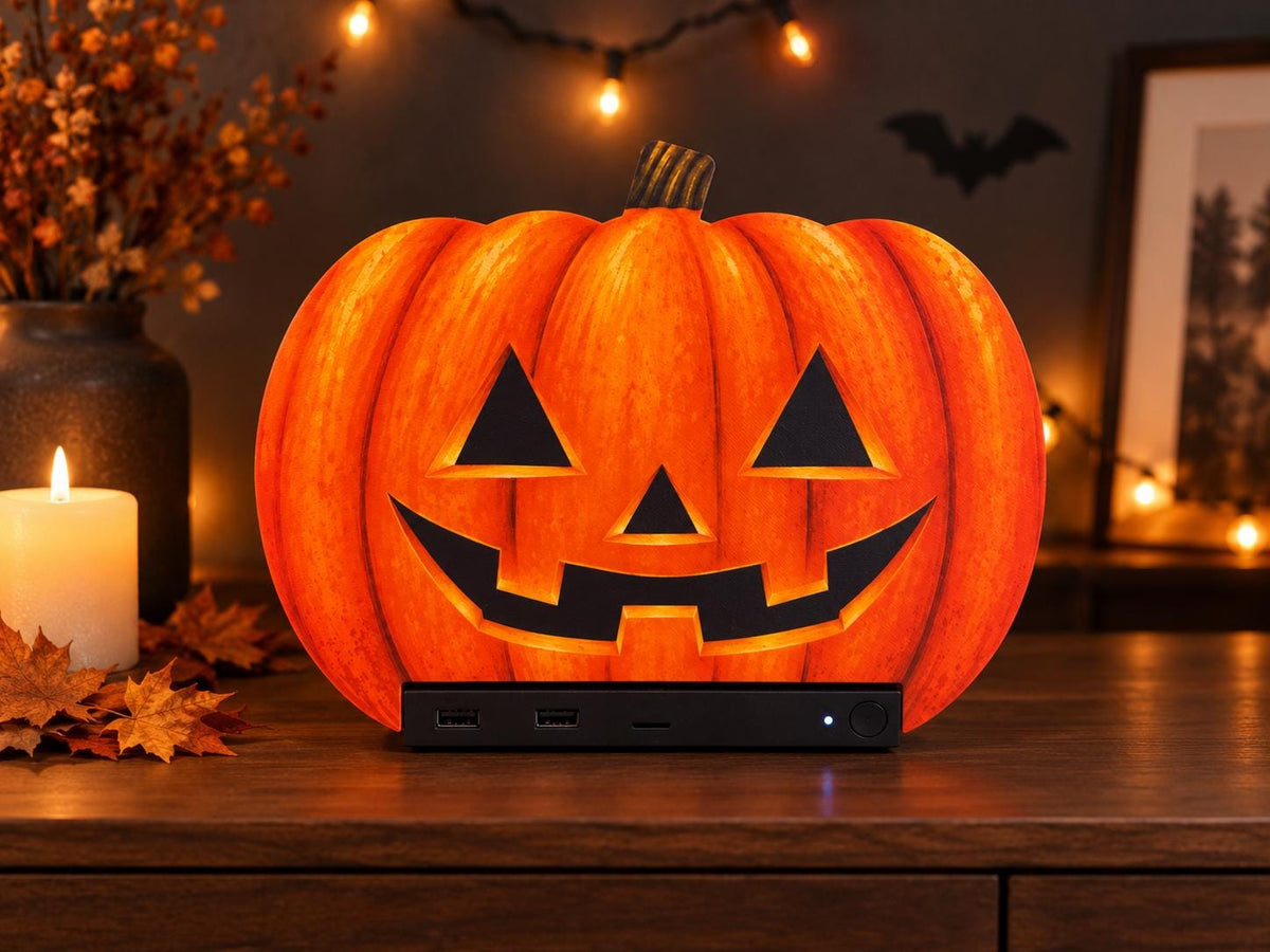 Steam Machine Faceplate Halloween Pumpkin, Classic or Cute Jack o Lantern Magnetic Plate, UV Printed Console Cover, Spooky Gamer Gif, promotional photo of the classic carved jack-o-lantern pumpkin faceplate installed on the Steam Machine on a wooden table, styled with a lit candle, autumn leaves, fairy lights and a bat silhouette
