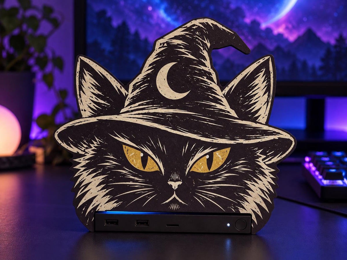 Steam Machine Faceplate Black Cat Witch Hat, Halloween Witchy Cat Magnetic Plate, UV Printed Console Cover, Spooky Gamer Gift, black cat witch hat faceplate installed on the Steam Machine on a desk in front of a computer monitor with purple ambient lighting and a backlit keyboard
