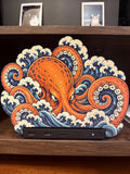Steam Machine Faceplate, Custom Faceplate, Kraken Kaiju Plate XL Oversized, Magnetic Console Cover, Octopus Gamer Gift, Japan Wave Decor, Kraken kaiju XL faceplate with a giant orange octopus rising out of Japanese waves, shown installed on the console on a wooden shelf with two framed cat photos on the shelf above