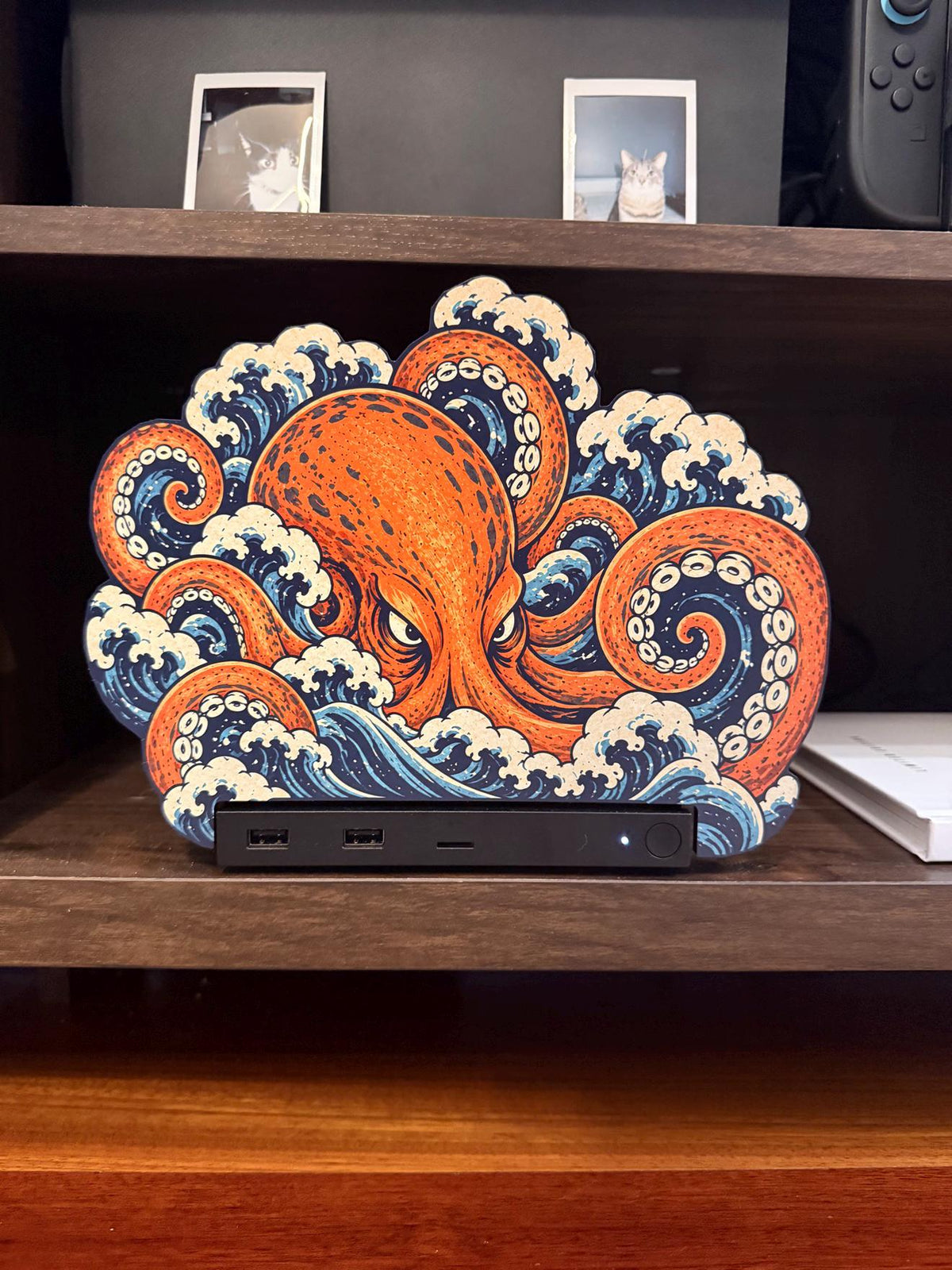 Steam Machine Faceplate, Custom Faceplate, Kraken Kaiju Plate XL Oversized, Magnetic Console Cover, Octopus Gamer Gift, Japan Wave Decor, close view of the Kraken kaiju XL faceplate with an orange octopus and curling blue and white Japanese waves, installed on the console on a wooden shelf