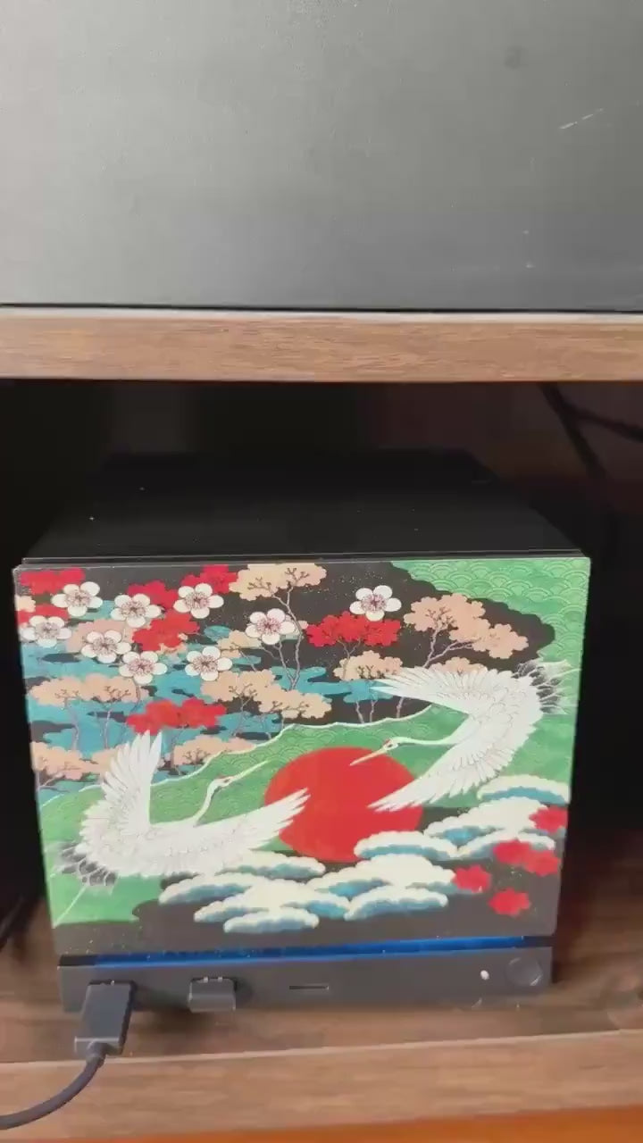 Japanese Crane Steam Machine Faceplate – UV Printed Front Panel | Red Sun & Cherry Blossom Art | Custom Mini PC Cover | Gamer Gift, video clip of the crane faceplate with two white cranes in flight over the red sun, shown installed on the console on a wooden shelf
