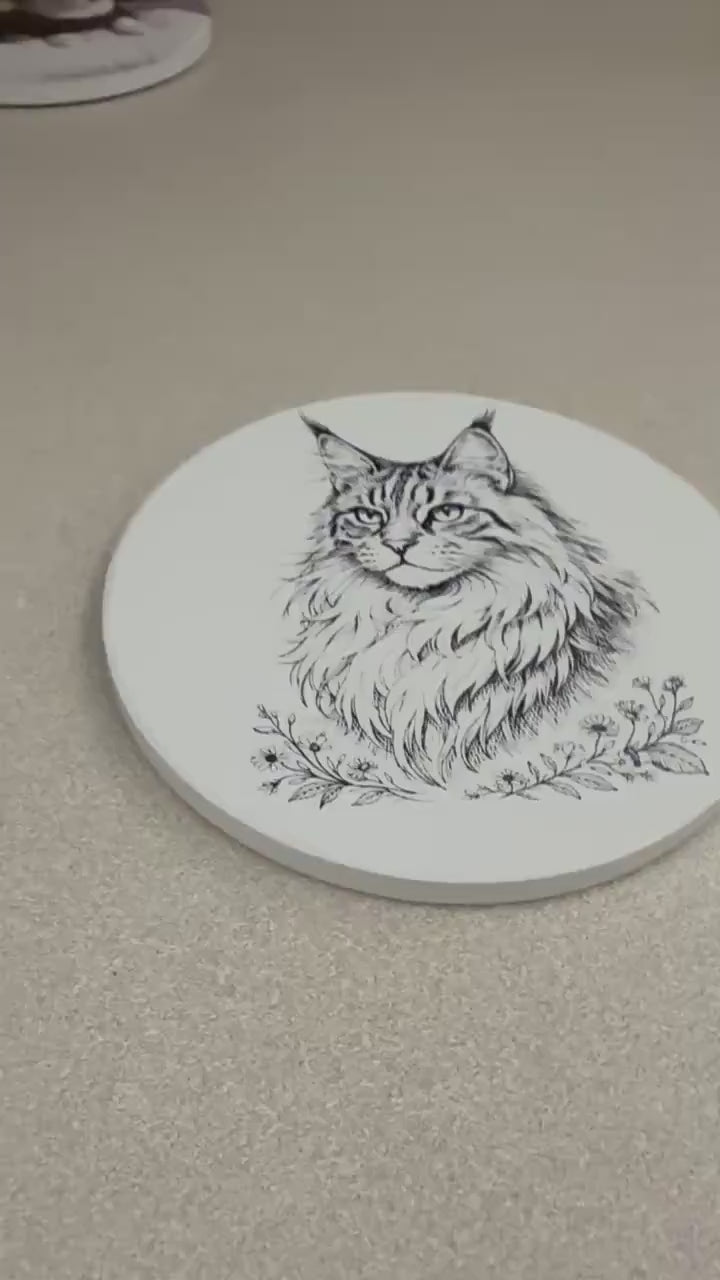 maine coon cat line art ceramic coaster cat lover gift idea pet portrait drink coaster housewarming gift cat mom home decor kitchen barware, video showing hands holding and turning the coaster to display the maine coon portrait front and the cork backing