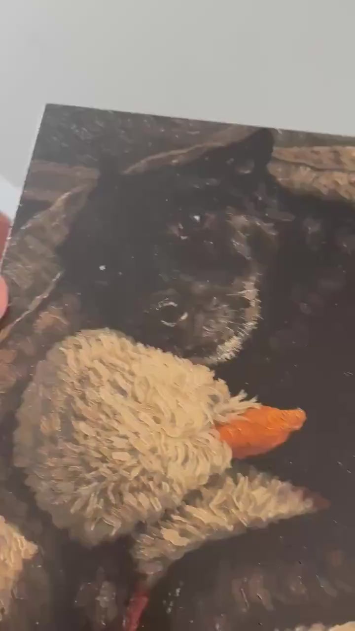 Custom Pet Portrait on Wood from Photo Textured Impasto Dog Painting 12x16, video showing a hand holding and tilting the impasto wood portrait of a black dog hugging a stuffed duck so the raised brushstroke texture catches the light